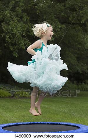 Happy girl bouncing on trampoline View Large Photo Image Stock Photo - Happy girl bouncing on trampoline. Fotosearch