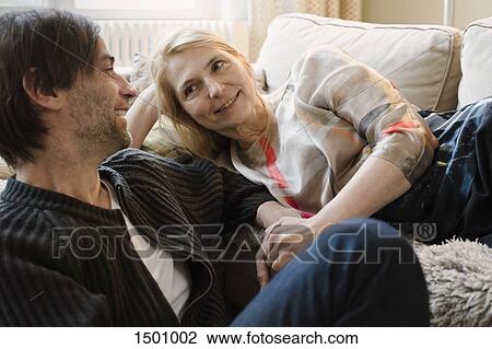 Stock Image - Happy mature couple looking at each other at home. Fotosearch