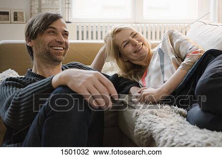 Stock Image - Happy mature couple spending leisure time at home. Fotosearch