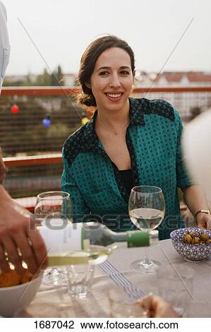 Happy woman sitting at outdoor lunch table on patio View Large Photo Image Stock Image - Happy woman sitting at outdoor lunch table on patio. Fotosearch