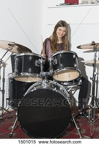 Happy young woman playing drums View Large Photo Image Stock Photography - Happy young woman playing drums. Fotosearch