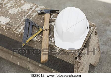 Hard-hat, hammer and ruler on bench View Large Photo Image Stock Image - Hard-hat, hammer and ruler on bench. Fotosearch