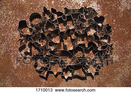 Stock Image - High angle close-up of various cookie cutters on table. Fotosearch