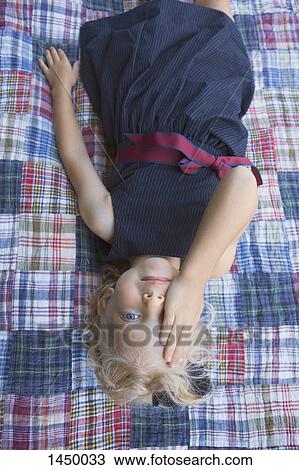 High angle portrait of girl covering eye while relaxing at backyard View Large Photo Image Stock Image - High angle portrait of girl covering eye while relaxing at backyard. Fotosearch