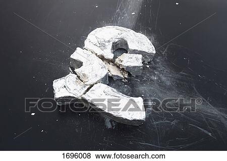 Stock Photo - High angle view of broken concrete Pound symbol on table. Fotosearch