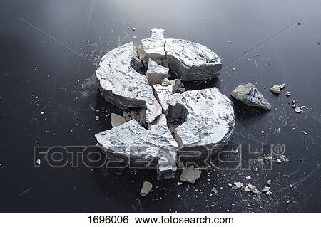 Stock Photograph - High angle view of broken concrete Dollar sign on table. Fotosearch