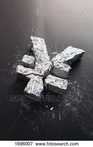 Stock Photo - High angle view of broken Yuan sign on black table. Fotosearch