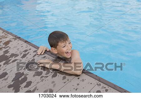 High angle view of cheerful shirtless boy swimming in pool View Large Photo Image Picture - High angle view of cheerful shirtless boy swimming in pool. Fotosearch