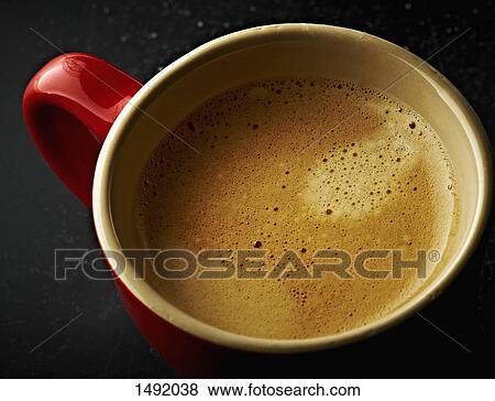 High angle view of coffee in red cup on table View Large Photo Image Stock Photo - High angle view of coffee in red cup on table. Fotosearch
