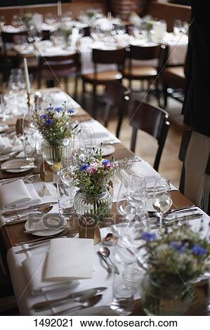 Stock Image - High angle view of dining tables arranged in restaurant. Fotosearch