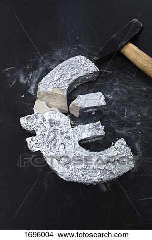 High angle view of Euro symbol with hammer on table View Large Photo Image Picture - High angle view of Euro symbol with hammer on table. Fotosearch