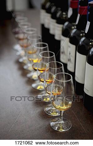 High angle view of glasses with Madeira wine by bottles on bar counter View Large Photo Image Stock Image - High angle view of glasses with Madeira wine by bottles on bar counter. Fotosearch