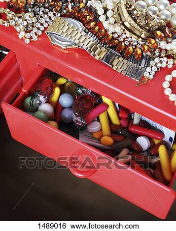 High angle view of medicines and jewelries on dressing table View Large Photo Image Stock Photograph - High angle view of medicines and jewelries on dressing table. Fotosearch