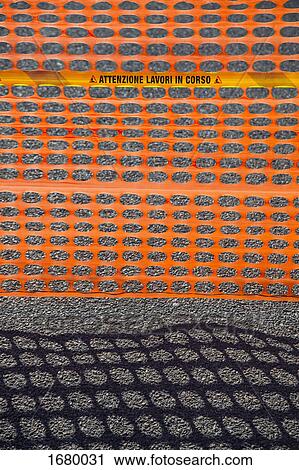 High angle view of orange fence with shadow on road View Large Photo Image Stock Image - High angle view of orange fence with shadow on road. Fotosearch