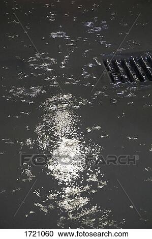 High angle view of rain water on street View Large Photo Image Stock Image - High angle view of rain water on street. Fotosearch