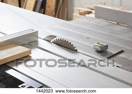 Stock Image - High angle view of sliding table saw in workshop. Fotosearch