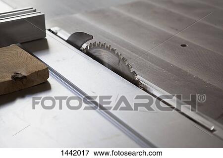 Stock Photo - High angle view of sliding table saw in workshop. Fotosearch