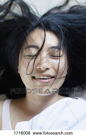High angle view of smiling young woman with closed eyes and messy hair lying on bed View Large Photo Image Stock Photo - High angle view of smiling young woman with closed eyes and messy hair lying on bed. Fotosearch
