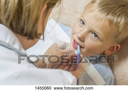 High angle view of speech therapist treating a boy View Large Photo Image Stock Image - High angle view of speech therapist treating a boy. Fotosearch