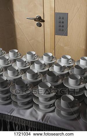 High angle view of stacked cups and saucers in cafe View Large Photo Image Picture - High angle view of stacked cups and saucers in cafe. Fotosearch