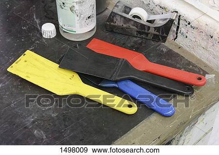Stock Photo - High angle view of tools and adhesive tape on table at printing press. Fotosearch