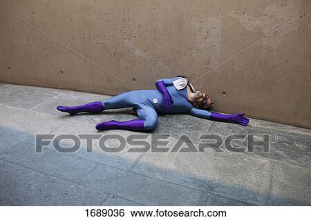 High angle view of unconscious superhero lying on footpath against wall View Large Photo Image Stock Photograph - High angle view of unconscious superhero lying on footpath against wall. Fotosearch