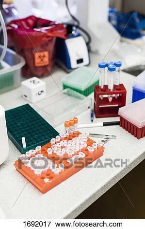 Stock Photo - High angle view of various scientific equipment on table at laboratory. Fotosearch
