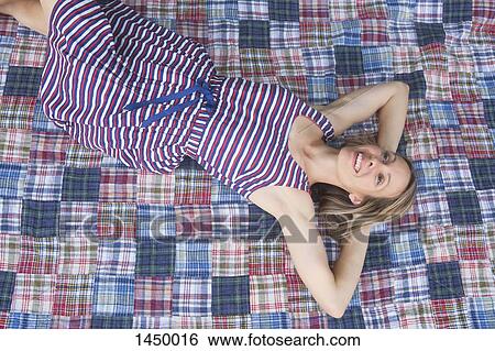 High angle view of woman relaxing on sheet in backyard View Large Photo Image Stock Photograph - High angle view of woman relaxing on sheet in backyard. Fotosearch