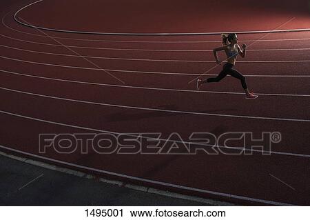 High angle view of young female athlete running on race track View Large Photo Image Stock Image - High angle view of young female athlete running on race track. Fotosearch