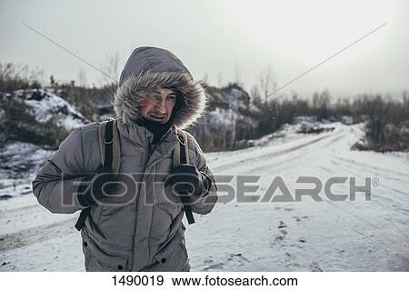 Hiker carrying backpack while standing on snow covered landscape View Large Photo Image Stock Photo - Hiker carrying backpack while standing on snow covered landscape. Fotosearch