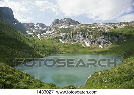 Idyllic view of Swiss Alps against sky View Large Photo Image Stock Photo - Idyllic view of Swiss Alps against sky. Fotosearch