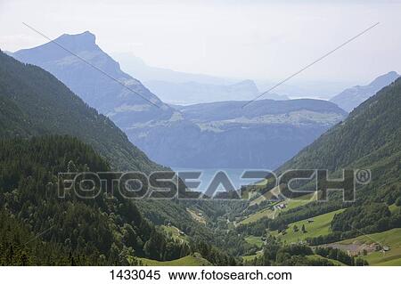 Idyllic view of Swiss Alps against sky View Large Photo Image Stock Photography - Idyllic view of Swiss Alps against sky. Fotosearch