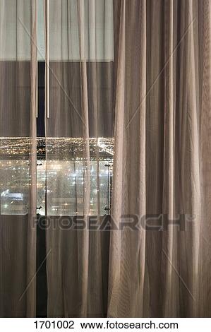 Illuminated city seen through curtains over window at night, Las Vegas, Nevada, USA View Large Photo Image Stock Image - Illuminated city seen through curtains over window at night, Las Vegas, Nevada, USA. Fotosearch