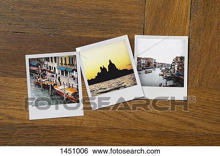 Instant print photographs of famous places on wooden table View Large Photo Image Stock Photograph - Instant print photographs of famous places on wooden table. Fotosearch
