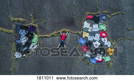 Knolling man holding up crack connecting clothing wardrobe View Large Photo Image Stock Image - Knolling man holding up crack connecting clothing wardrobe. Fotosearch