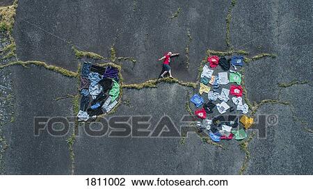 Stock Image - Knolling of man walking on crack between clothing wardrobe. Fotosearch