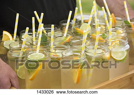 Stock Photograph - Lemonade in mason jars with drinking straws. Fotosearch