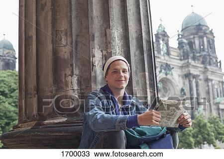 Low angle portrait of young male tourist sitting with map at Altes Museum, Berlin, Germany View Large Photo Image Stock Image - Low angle portrait of young male tourist sitting with map at Altes Museum, Berlin, Germany. Fotosearch