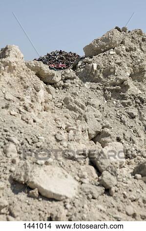 Low angle view of garbage heap and rock View Large Photo Image Picture - Low angle view of garbage heap and rock. Fotosearch