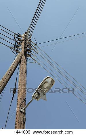 Low angle view of street light and electricity pylon against clear sky View Large Photo Image Stock Image - Low angle view of street light and electricity pylon against clear sky. Fotosearch