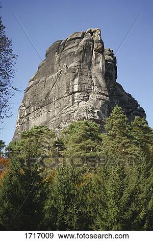 Low angle view of trees by rock formation against clear blue sky, Elbe Sandstone Mountains, Germany View Large Photo Image Stock Photo - Low angle view of trees by rock formation against clear blue sky, Elbe Sandstone Mountains, Germany. Fotosearch