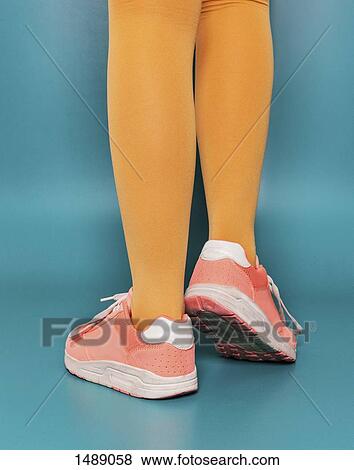 Low section of person standing on blue background View Large Photo Image Stock Photo - Low section of person standing on blue background. Fotosearch