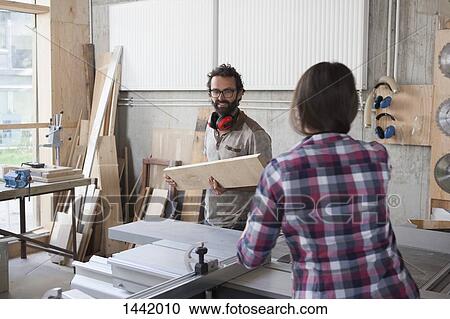 Male and female carpenters working together in workshop View Large Photo Image Stock Image - Male and female carpenters working together in workshop. Fotosearch