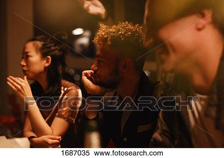 Male and female friends talking during party at home View Large Photo Image Stock Photography - Male and female friends talking during party at home. Fotosearch