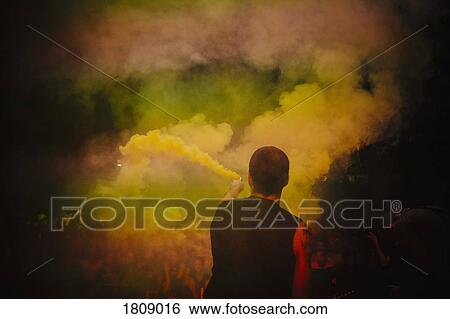 Male DJ on stage holding smoke bomb View Large Photo Image Stock Photograph - Male DJ on stage holding smoke bomb. Fotosearch