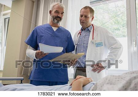 Male doctors making rounds in hospital room View Large Photo Image Stock Image - Male doctors making rounds in hospital room. Fotosearch