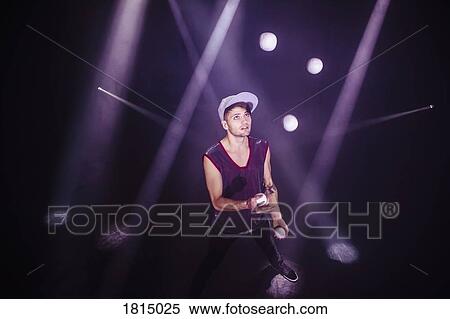 Stock Photography - Male performer juggling on stage. Fotosearch