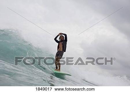 Male surfer riding ocean wave View Large Photo Image Stock Photo - Male surfer riding ocean wave. Fotosearch