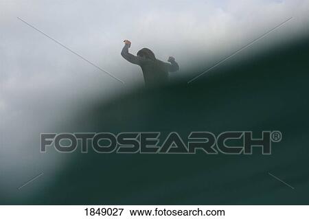 Stock Photo - Male surfer riding ocean wave. Fotosearch