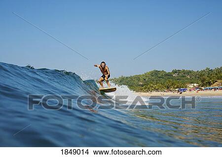 Male surfer riding wave, Sayulita, Nayarit, Mexico View Large Photo Image Picture - Male surfer riding wave, Sayulita, Nayarit, Mexico. Fotosearch